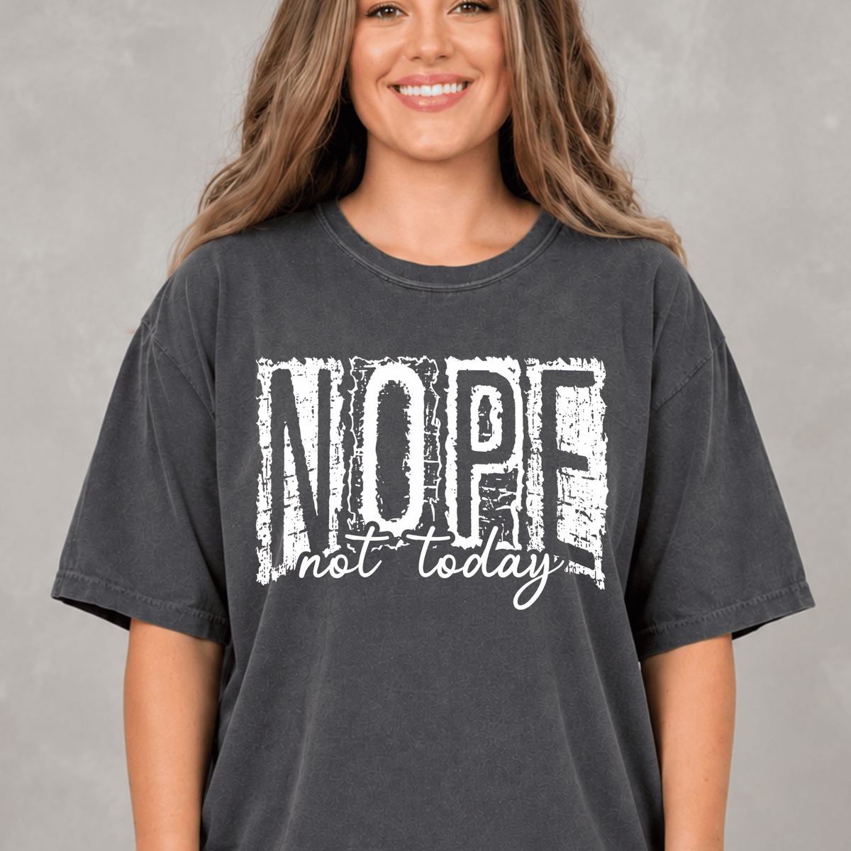 A woman wearing a black t-shirt with the text "NOPE not today" printed on it.