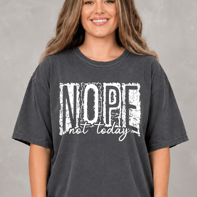 A woman wearing a black t-shirt with the text "NOPE not today" printed on it.