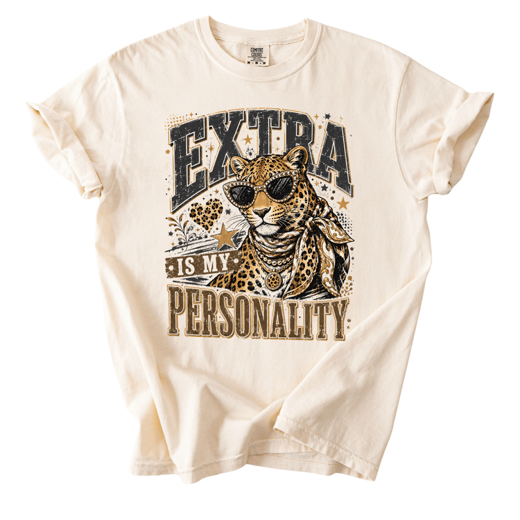 a white t-shirt with a graphic design of a leopard wearing sunglasses and the text "EXTRA IS MY PERSONALITY" printed on it.