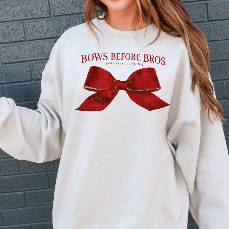 A white sweatshirt with a red bow and text printed on it.