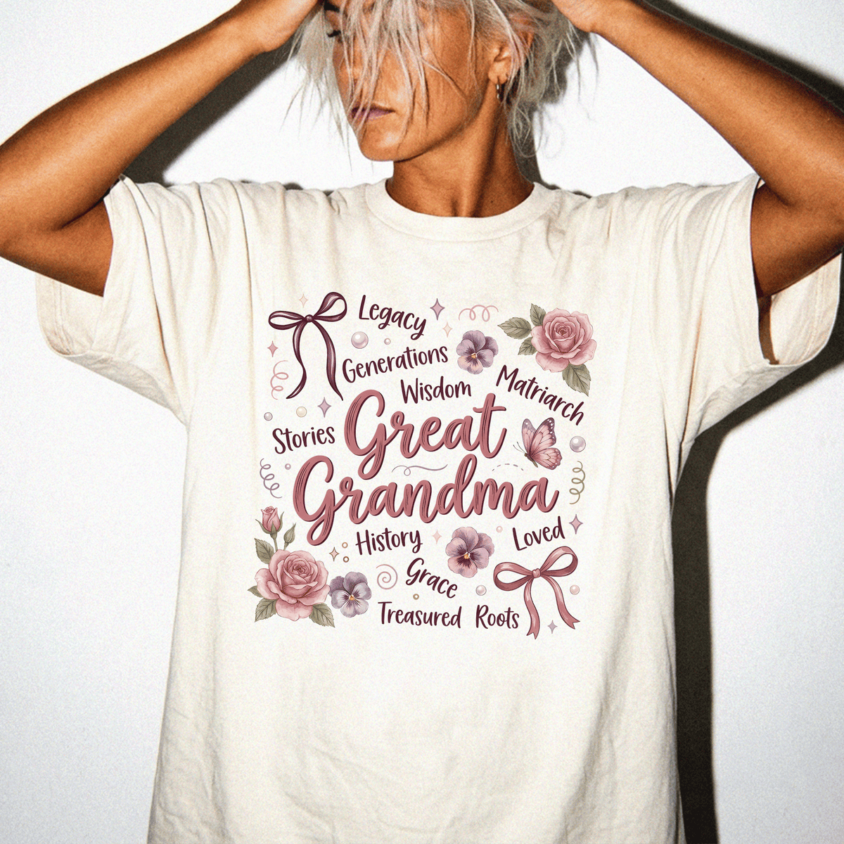 A woman wearing a white t-shirt with a floral design and text printed on it.