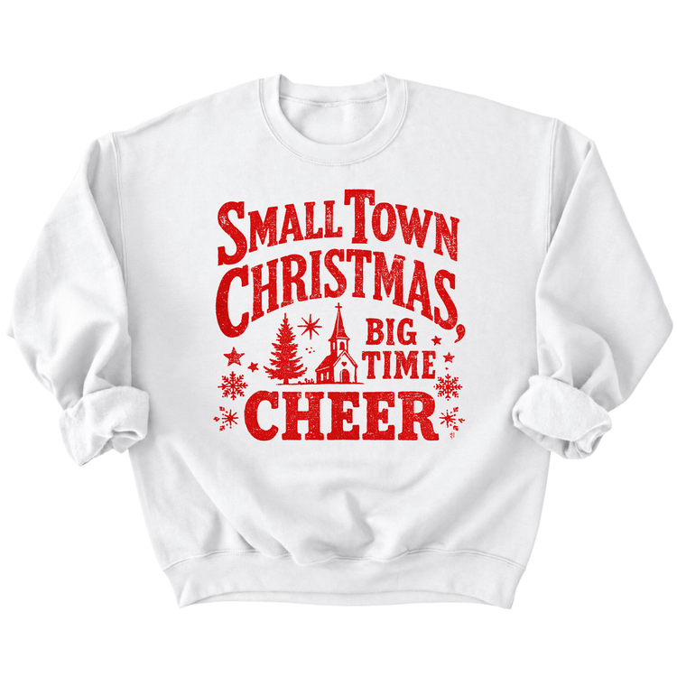 A white sweatshirt with a red graphic design that says "Small Town Christmas Big Time Cheer" printed on it.