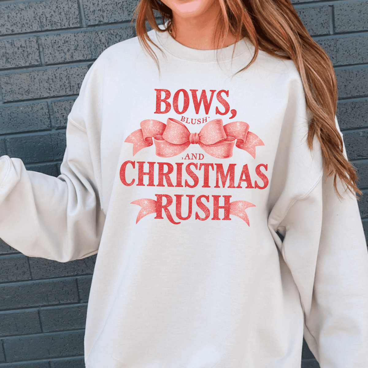 A white sweatshirt with a red bow and text printed on it.