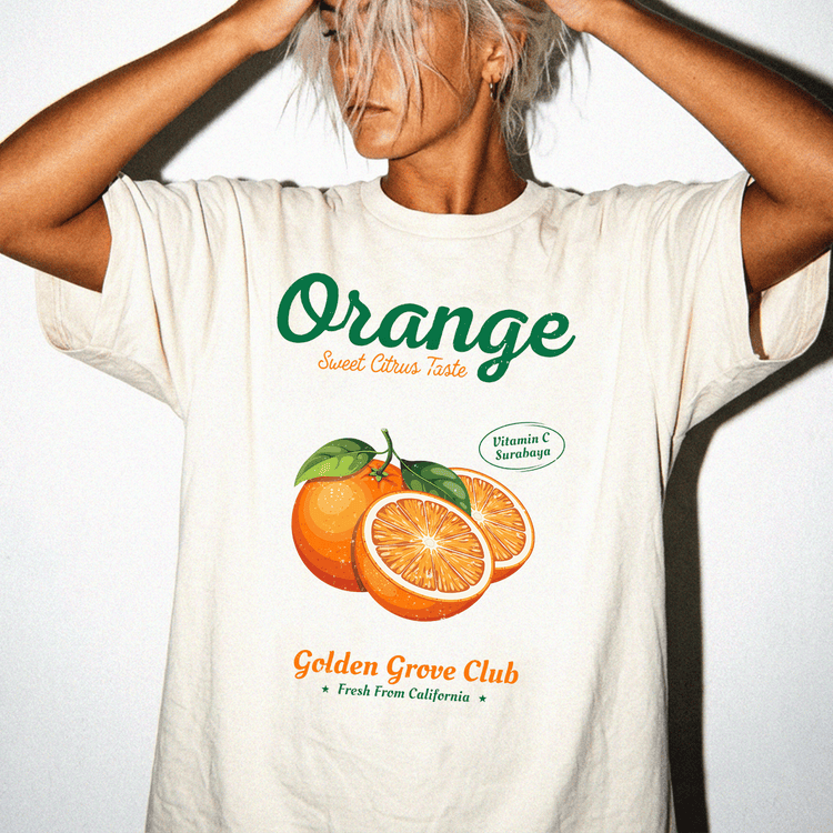 A person wearing a white t-shirt with an orange graphic and text, standing against a white background.