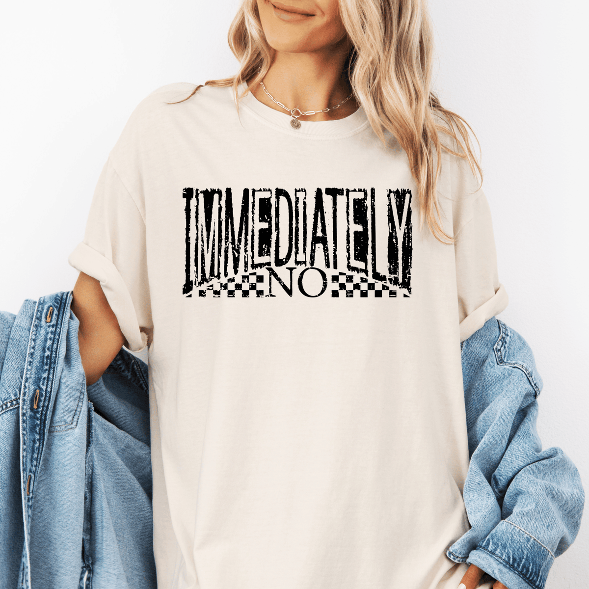 A woman wearing a white t-shirt with the text "IMMEDIATELY NO" printed on it.