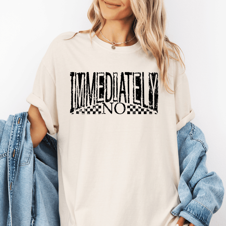 A woman wearing a white t-shirt with the text "IMMEDIATELY NO" printed on it.