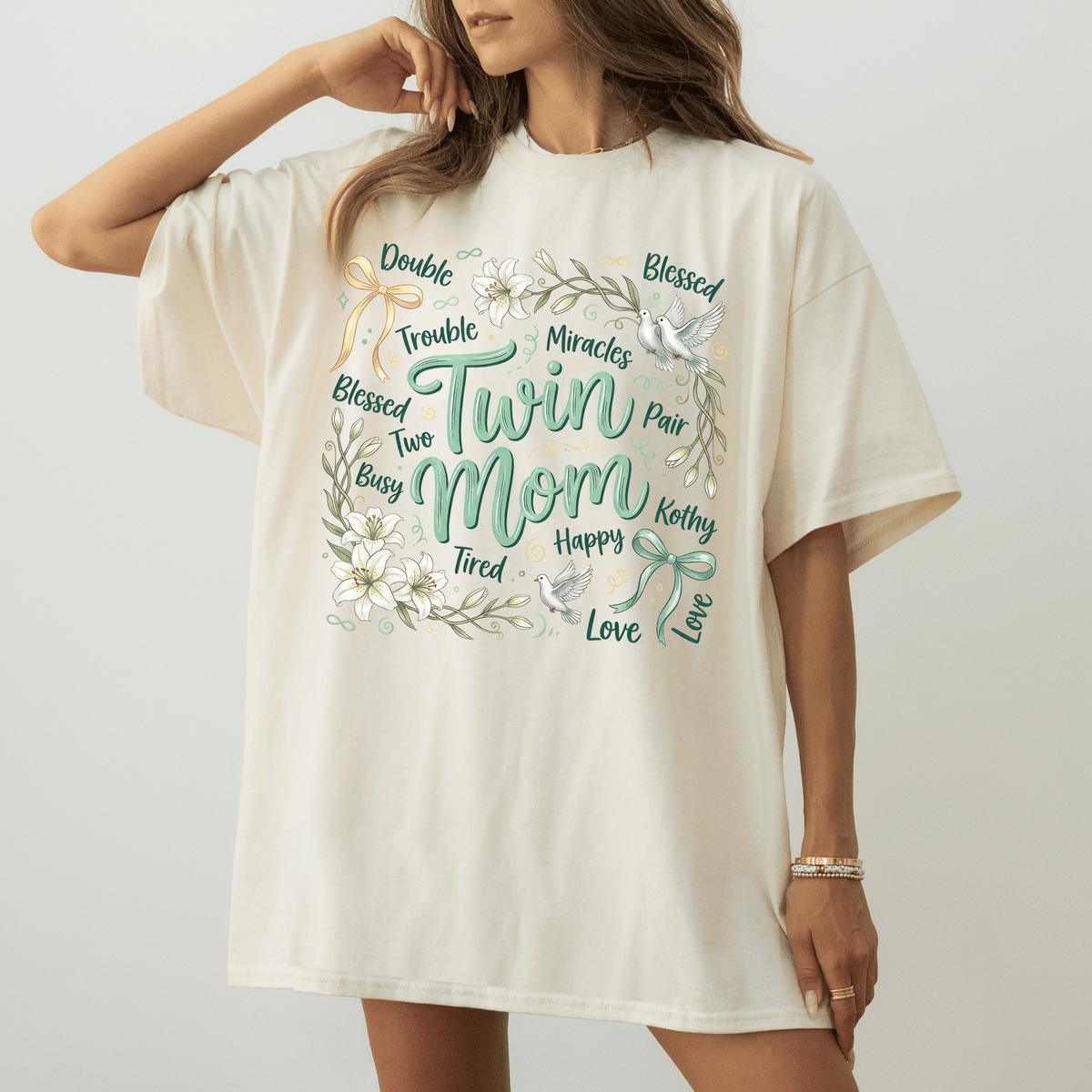 A woman wearing a white t-shirt with a floral design and text printed on it.
