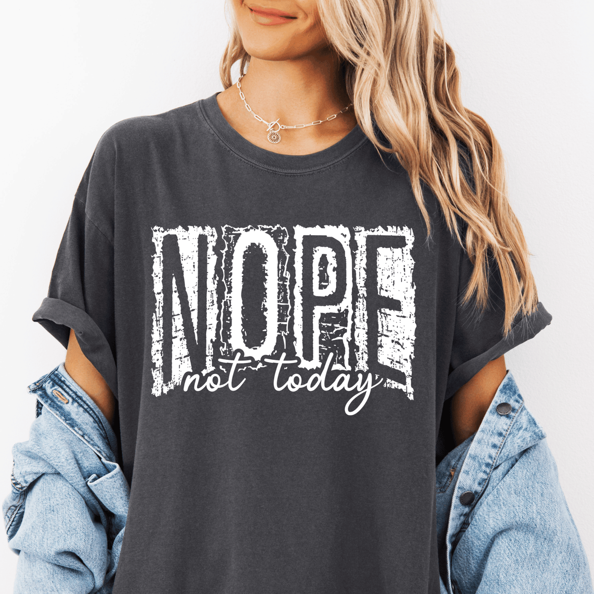 A woman wearing a black t-shirt with the text "NOPE not today" printed on it.