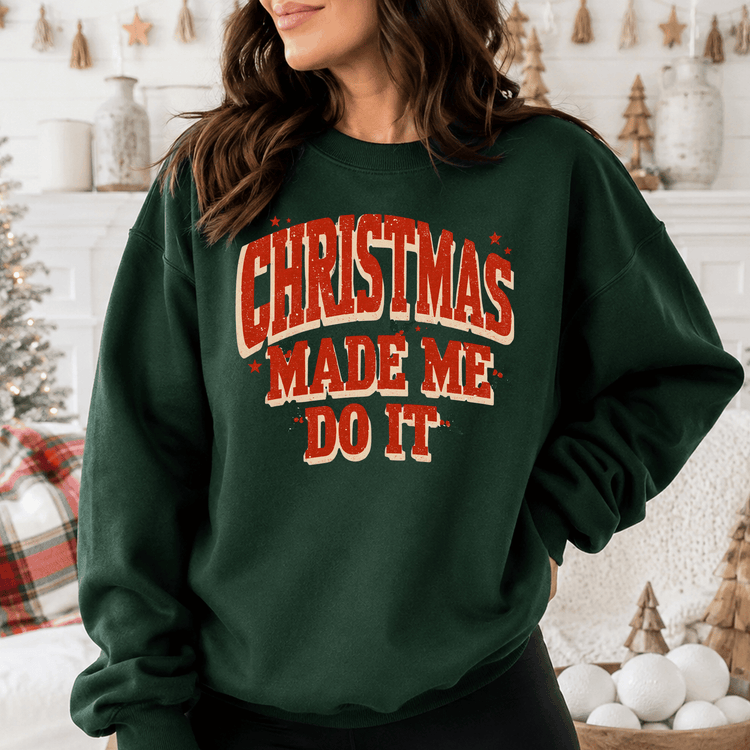 A woman wearing a green sweatshirt with the text "Christmas Made Me Do It" printed on it.