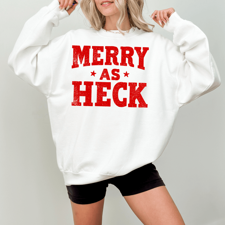 A woman wearing a white sweatshirt with the text "MERRY AS HEK" printed on it.