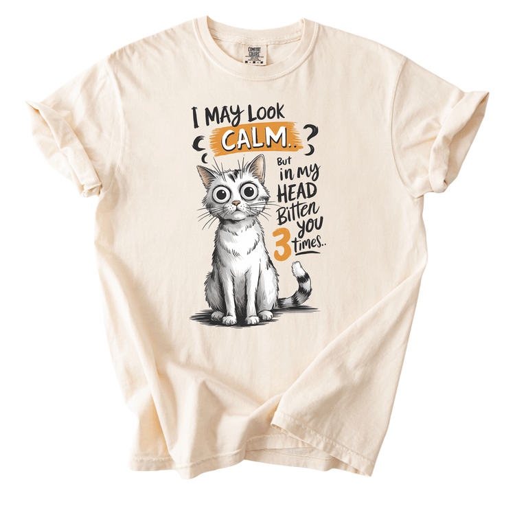 A t-shirt with a cartoon cat and text that says "I may look calm, but in my head, I bitten you 3 times."