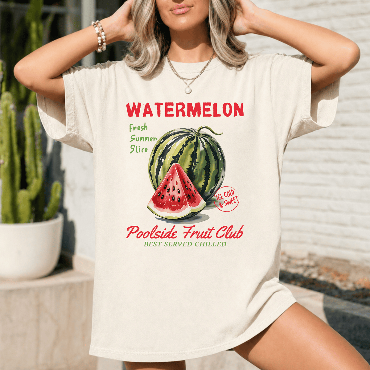 A woman wearing a white t-shirt with a graphic design of a watermelon and text promoting a fruit club.