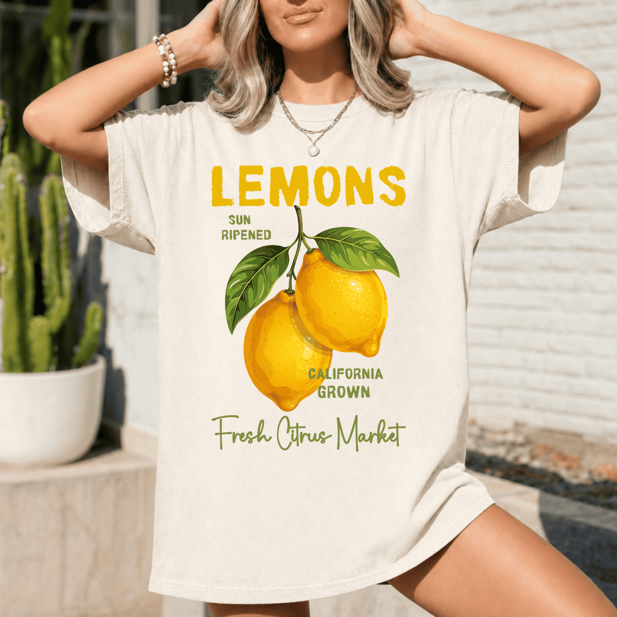 A woman wearing a white t-shirt with a graphic design of lemons and text related to the fresh citrus market.