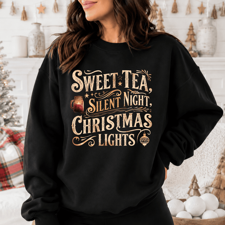 A woman wearing a black sweatshirt with a Christmas-themed design, including text and a mug icon.