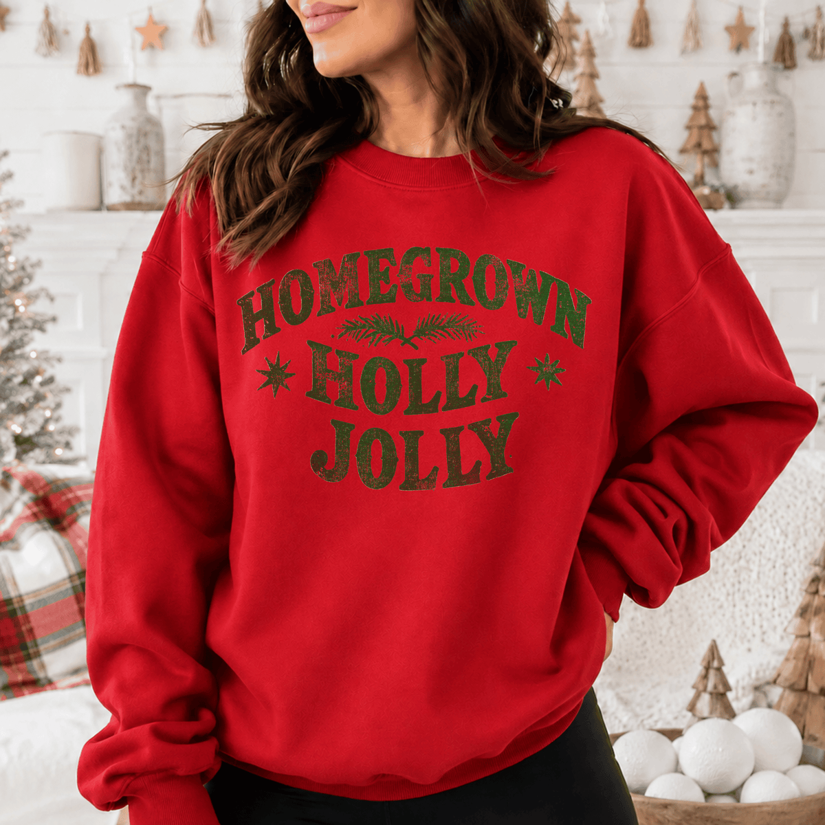 A woman wearing a red sweatshirt with the text "HOMEGROWN HOLY JOYL" printed on it.
