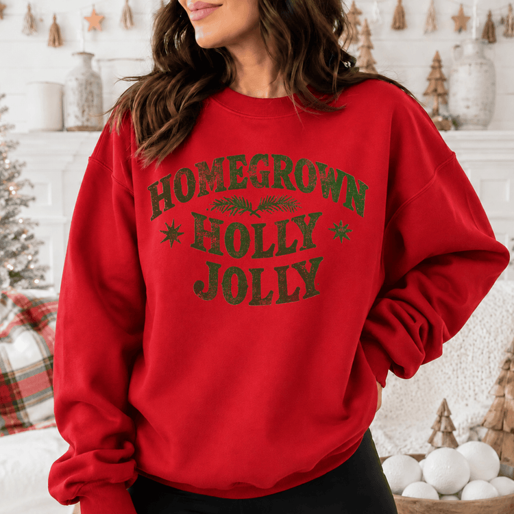 A woman wearing a red sweatshirt with the text "HOMEGROWN HOLY JOYL" printed on it.
