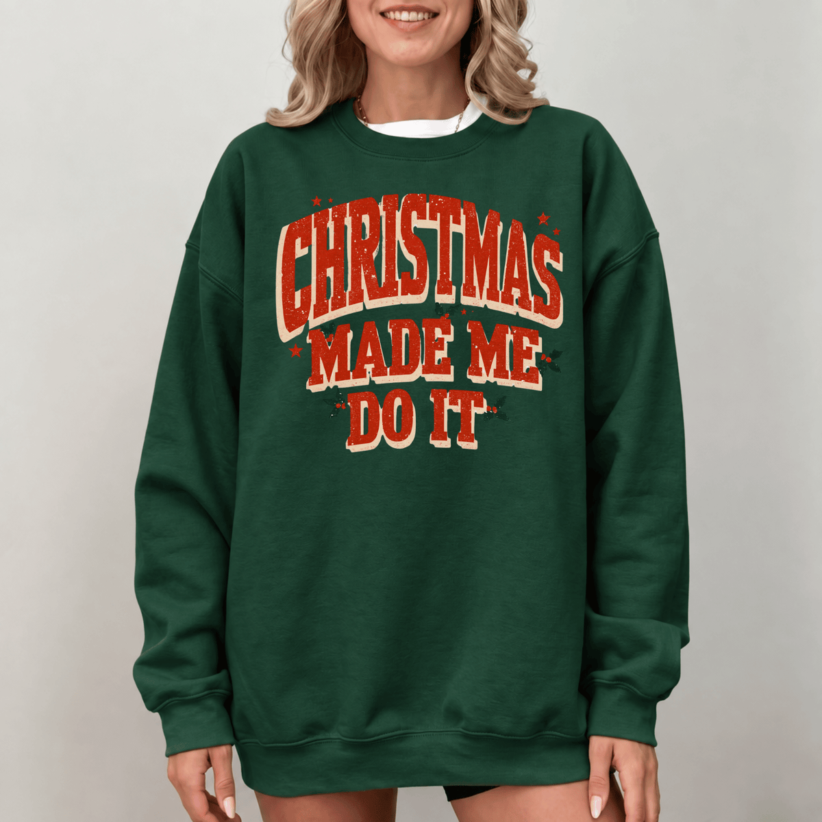A woman wearing a green sweatshirt with the text "Christmas Made Me Do It" printed on it.