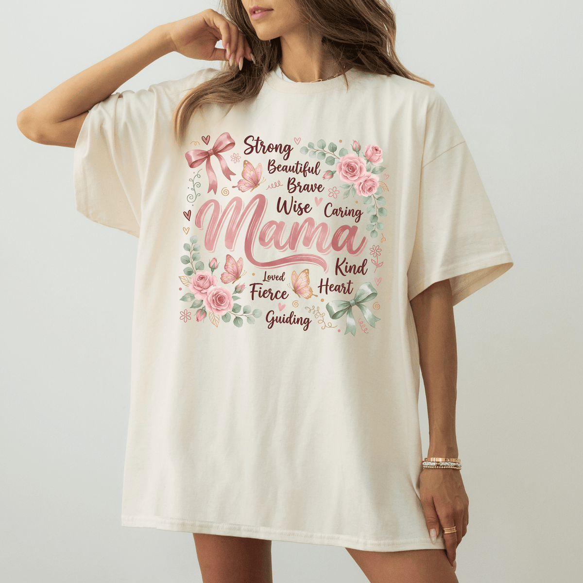 A woman wearing a white t-shirt with a floral design and text printed on it.