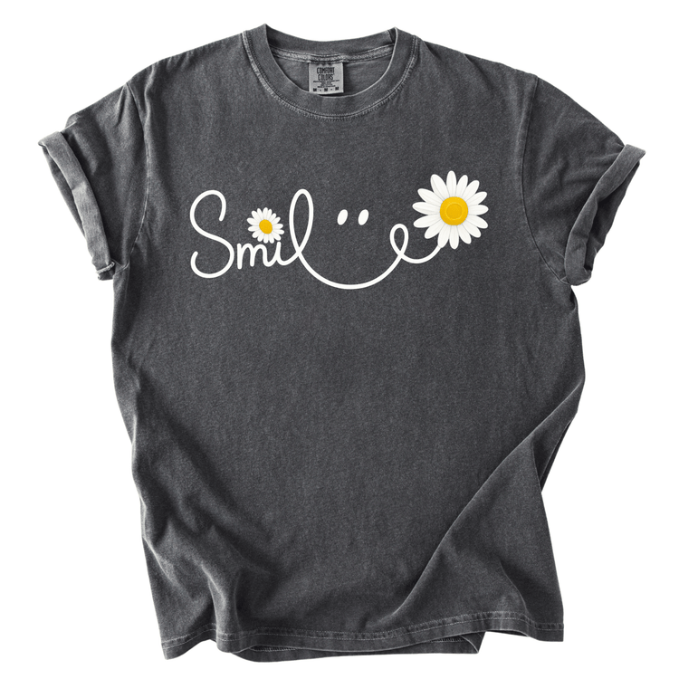 A gray t-shirt with a white smiley face design and two white daisies on the left side.