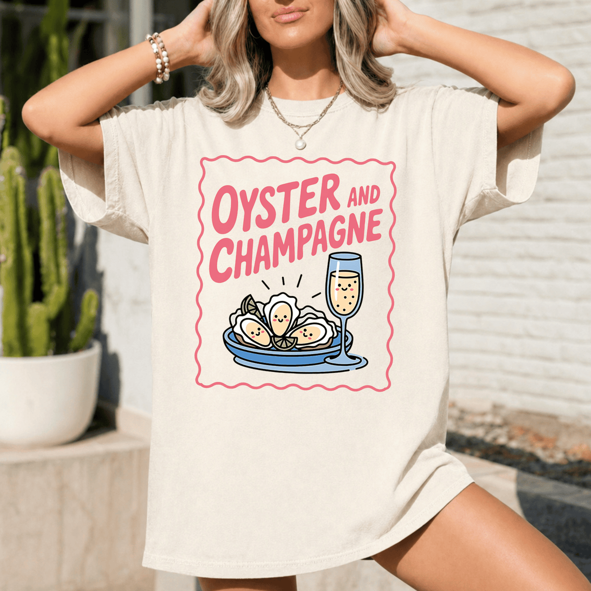 A woman wearing a white t-shirt with a graphic design of a glass of champagne and oysters.