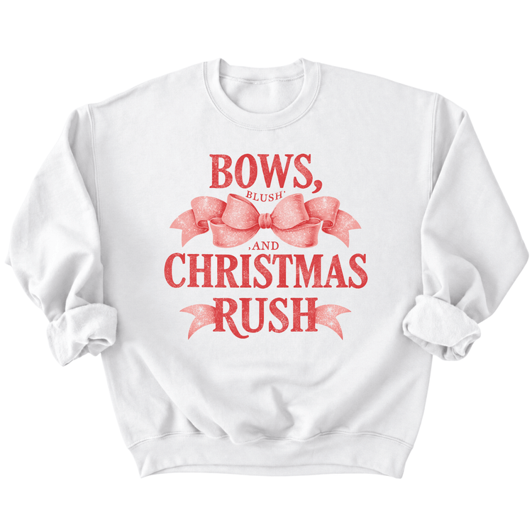 A white sweatshirt with a red graphic design that says "BOWS, BLUSH, AND CHRISTMAS RUSH" along with a bow and ribbon.