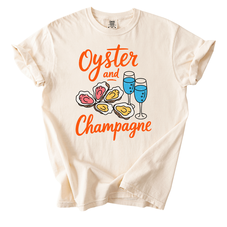 A white t-shirt with a graphic design featuring a pair of glasses and a plate of oysters, along with the text "Oyster and Champagne".