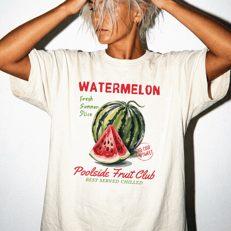 A person wearing a white t-shirt with a graphic of a watermelon and text promoting a fruit club.