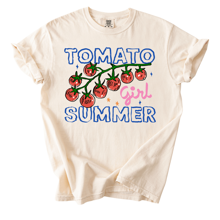 A white t-shirt with a graphic design featuring a branch of tomatoes and the text "Tomato Girl Summer" printed on it.