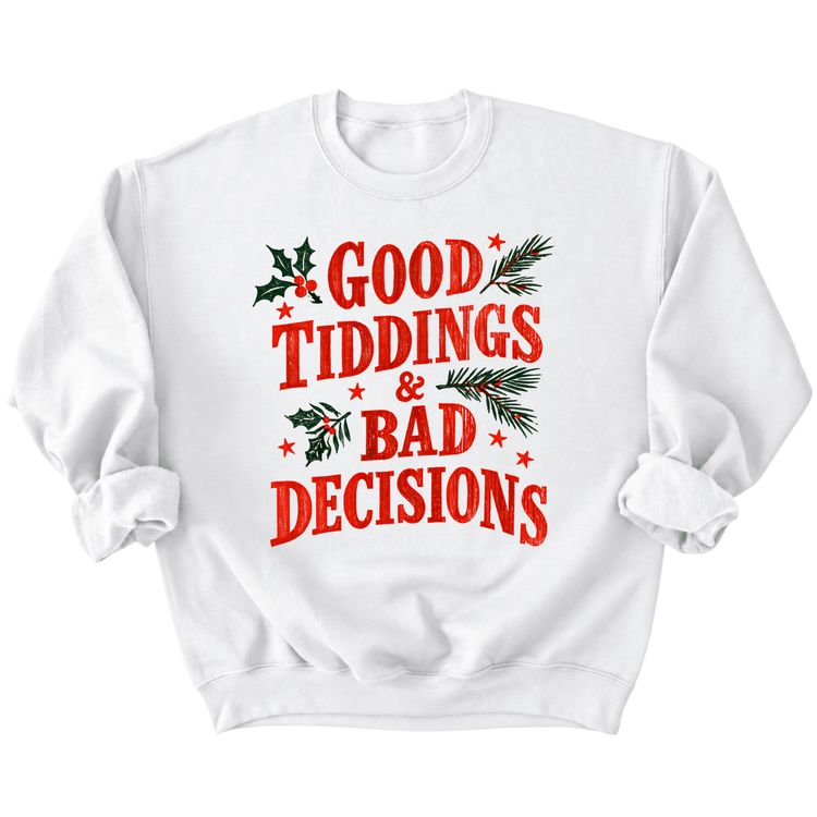 A white sweatshirt with a red and green text design that reads "GOOD TIDDINGS & BAD DECISIONS".