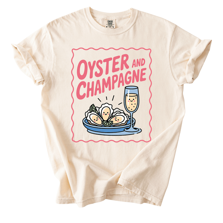 a white t-shirt with a graphic design depicting a glass of champagne and a plate of oysters.