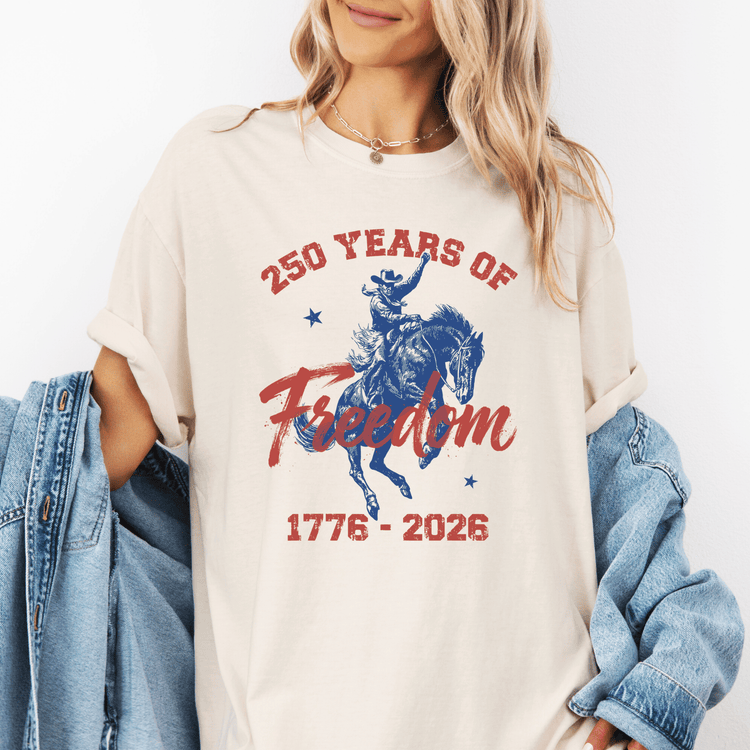 A woman wearing a white t-shirt with a graphic design and text printed on it.