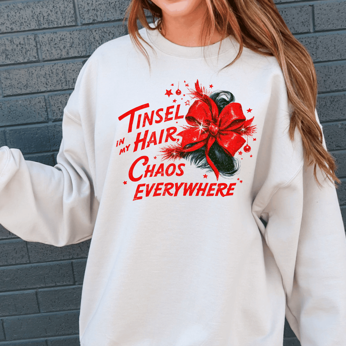 A white sweatshirt with a red bow and text printed on it.