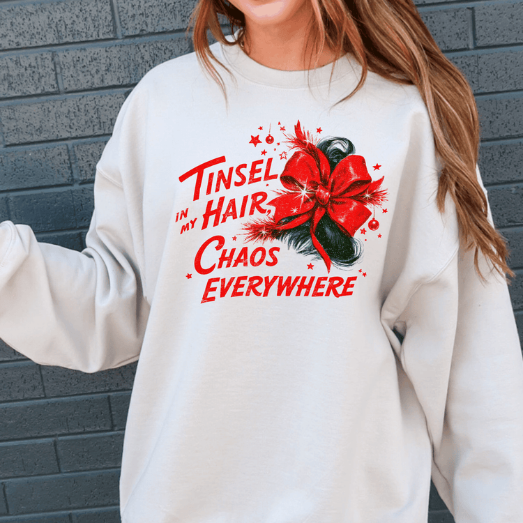 A white sweatshirt with a red bow and text printed on it.