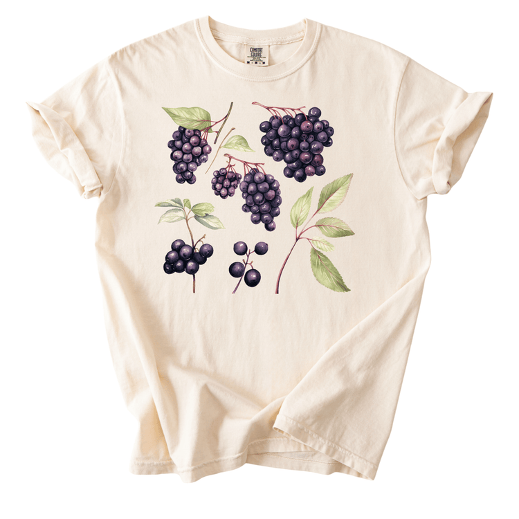 A white t-shirt with a graphic design of various purple grapes and leaves printed on it.
