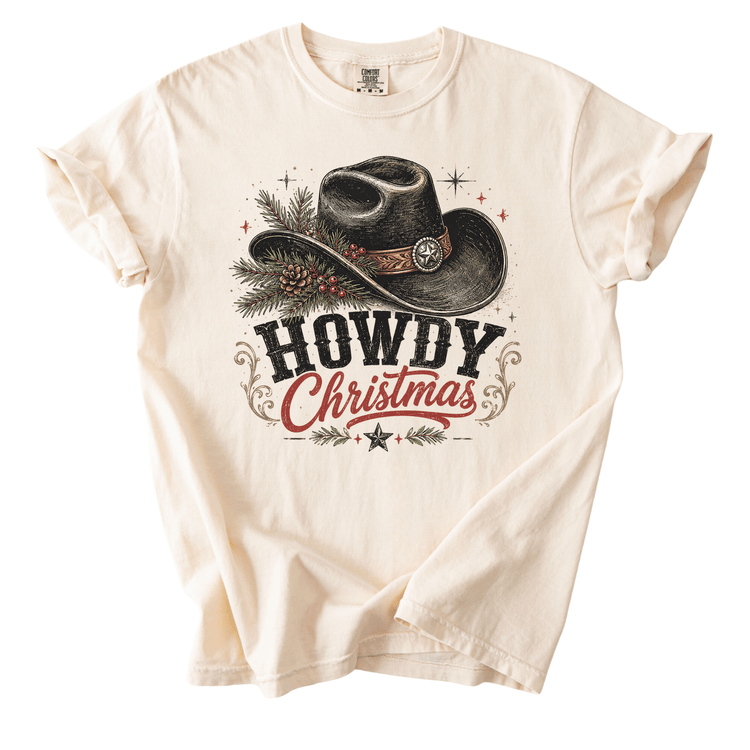 A white t-shirt with a graphic design featuring a cowboy hat and the text "HOWDY CHRISTMAS" printed on it.