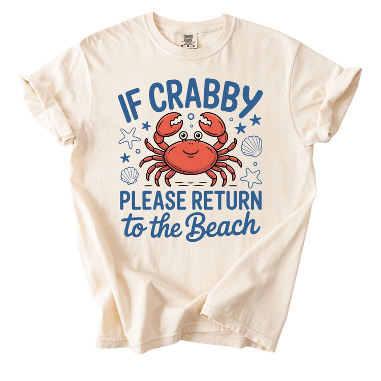 a white t-shirt with a graphic design of a crab and the text "IF CRABBY PLEASE RETURN TO THE BEACH" printed on it.