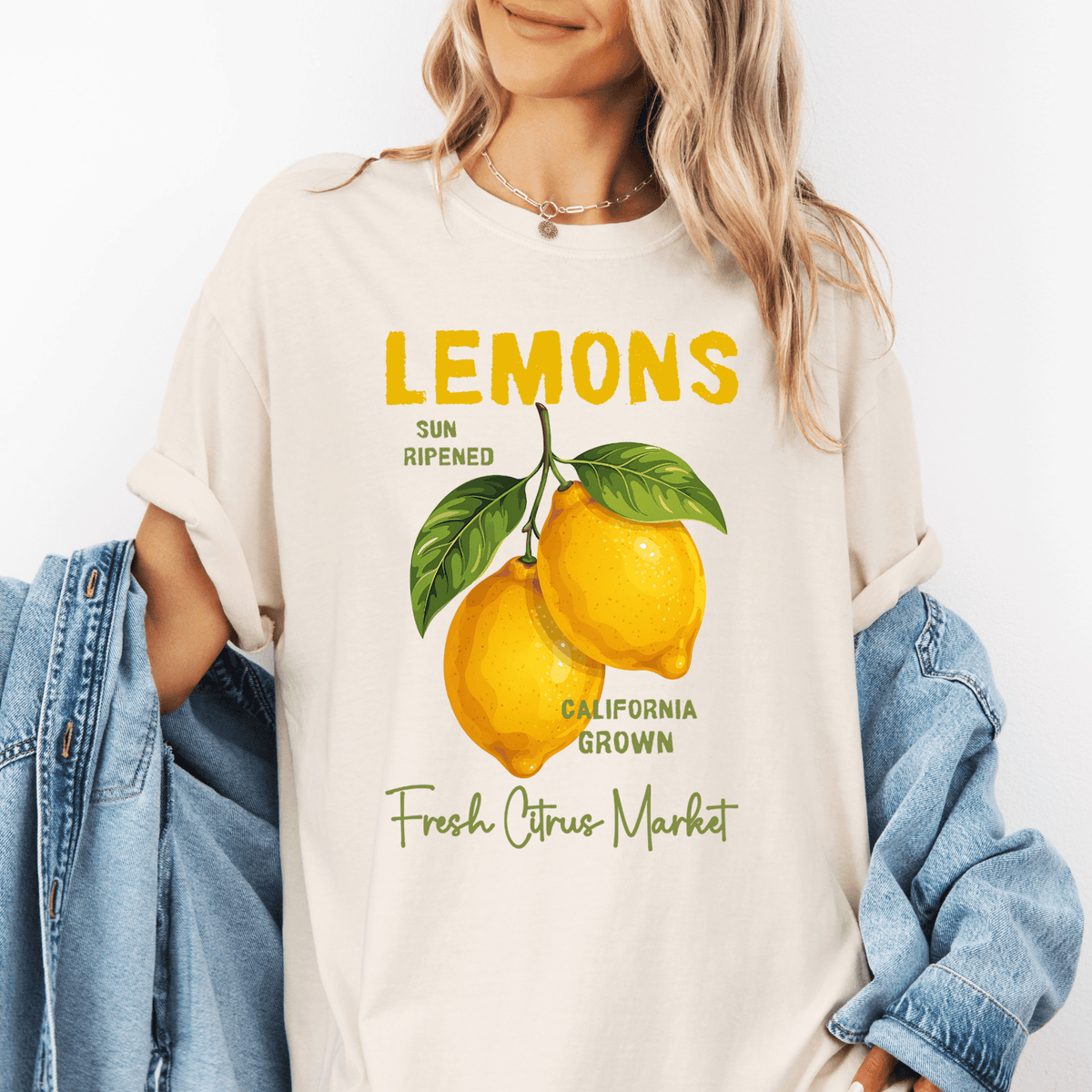 A woman wearing a white t-shirt with a graphic design of lemons and text promoting California grown lemons.