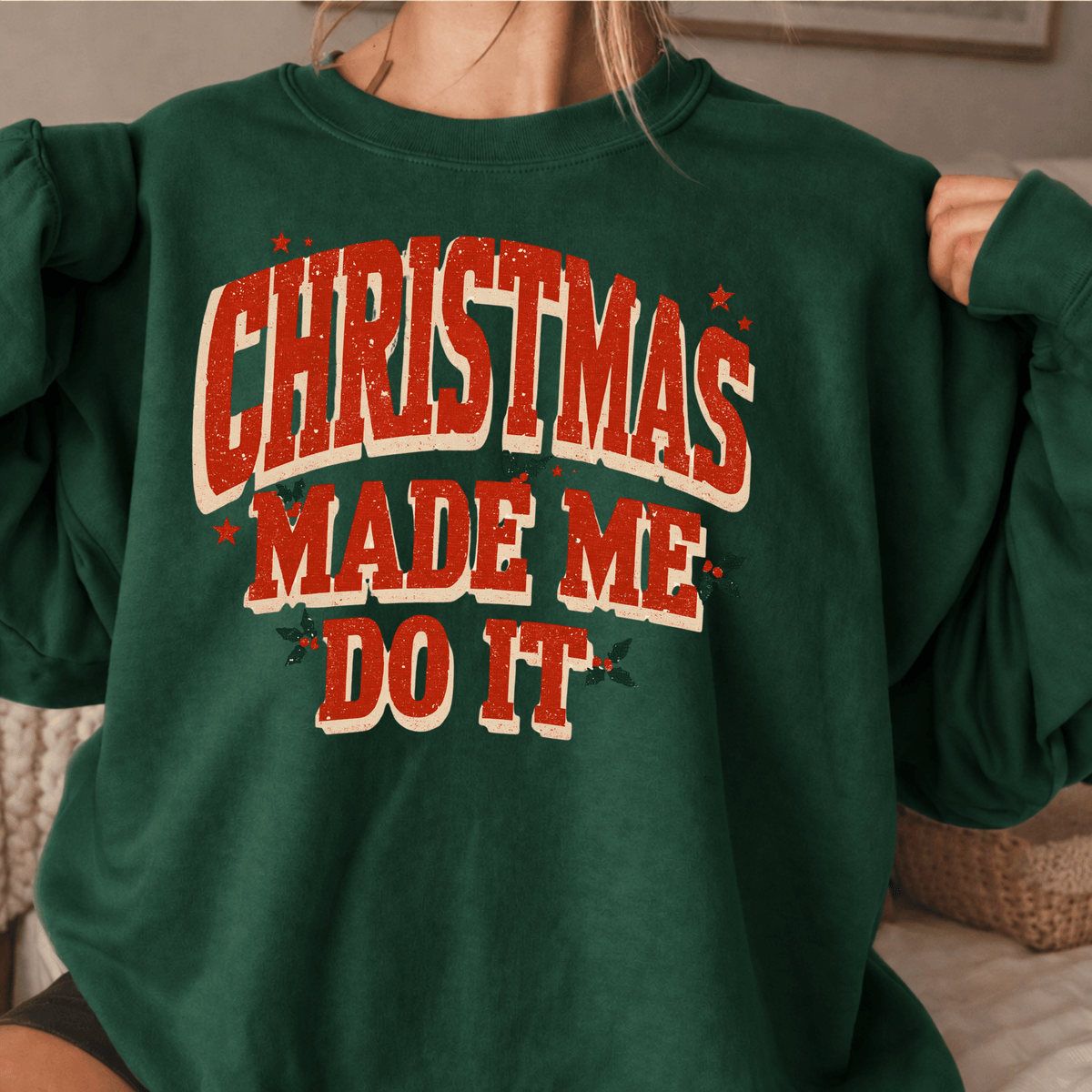 A person wearing a green sweatshirt with the text "Christmas Made Me Do It" printed on it.