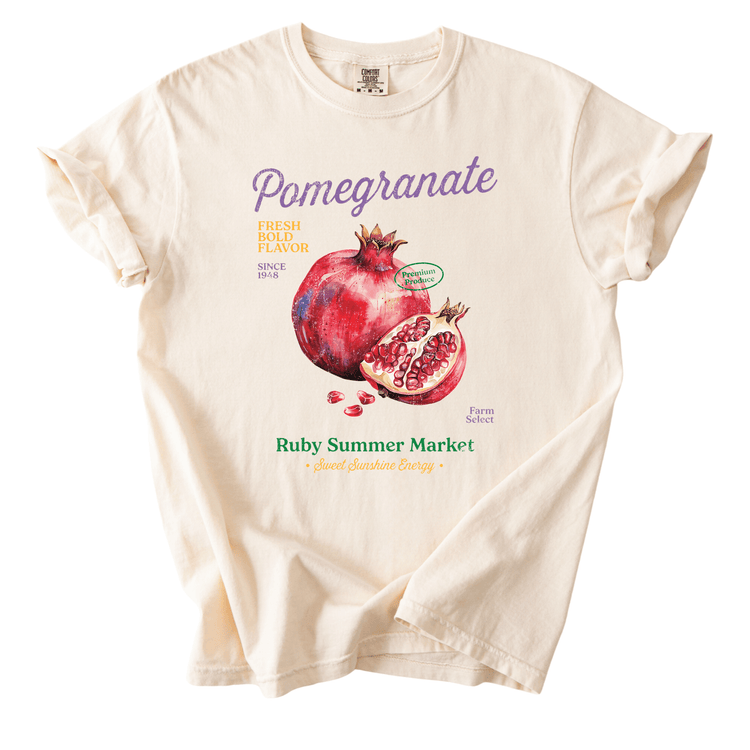 The image is a white t-shirt with a graphic design featuring a pomegranate and text that reads "Pomegranate" and "Ruby Summer Market".