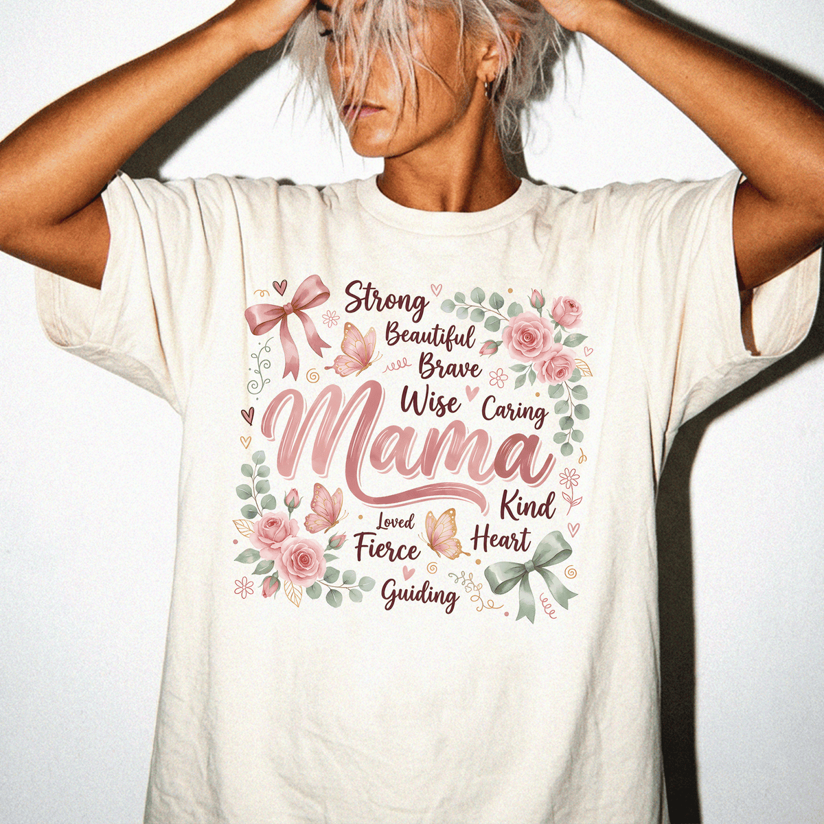A woman wearing a white t-shirt with a floral design and text printed on it.