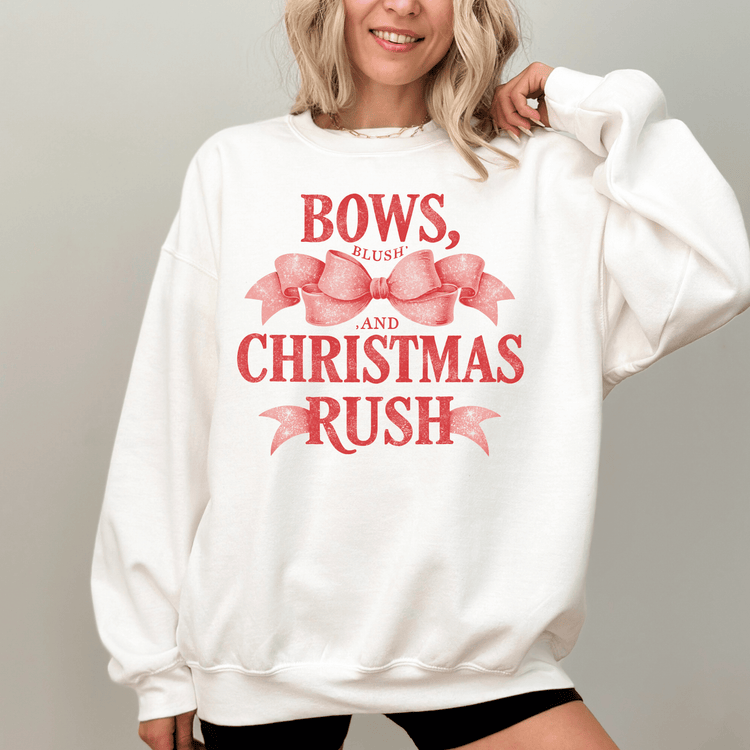 A woman wearing a white sweatshirt with a red bow and text printed on it.