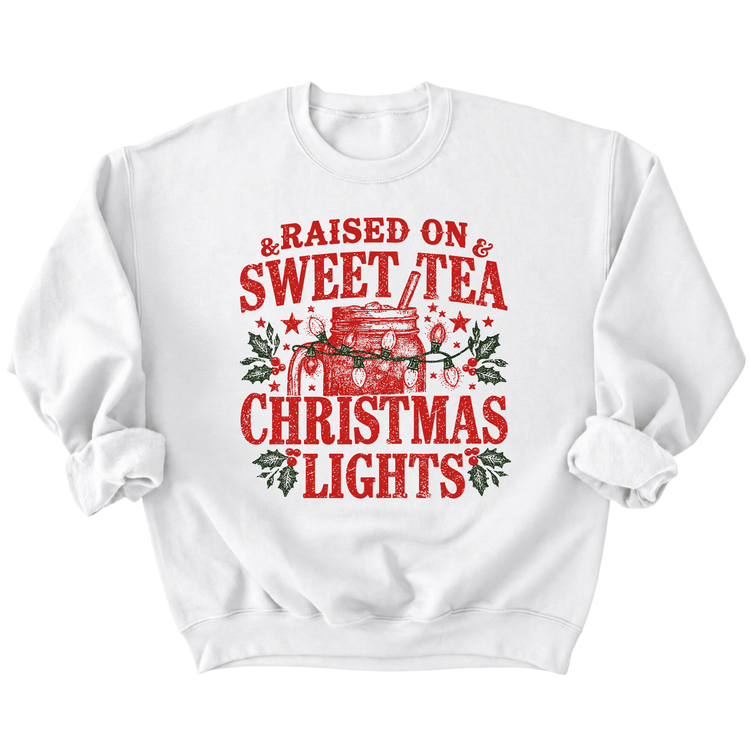 A white sweatshirt with a red and green graphic design that says "Raised on & Sweet Tea Christmas Lights".
