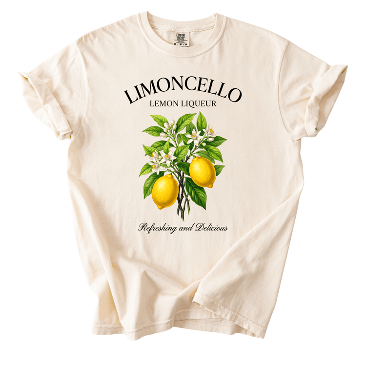 A white t-shirt with a graphic design featuring a lemon tree and lemons, along with the text "LIMONCELLO LEMON LIQUEUR" and "Refreshing and Delicious".