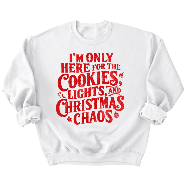 A white sweatshirt with a red text design that reads "I'M ONLY HERE FOR THE COOKIES, LIGHTS, AND CHRISTMAS CHAOS".