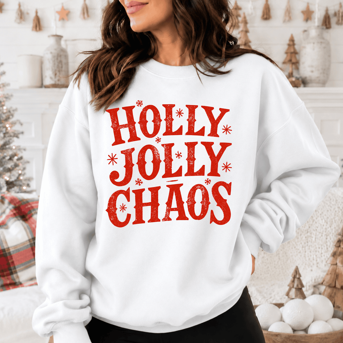A woman wearing a white sweatshirt with the text "HOLY JOLTY CHAOS" printed on it.