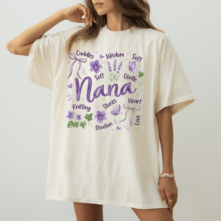 a woman wearing a white t - shirt with purple flowers on it