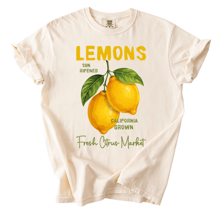 A white t-shirt with a graphic design featuring two lemons and the text "LEMONS" prominently displayed.