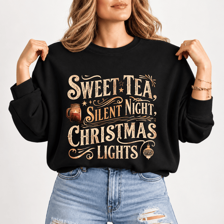 A woman wearing a black sweatshirt with a printed design that says "Sweet Tea, Silent Night, Christmas Lights".
