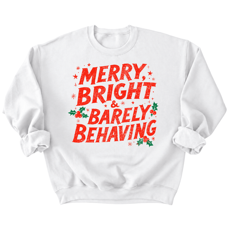 A white sweatshirt with a red and green text design that says "MERRY BRIGHT & BARELY BEHAVING".