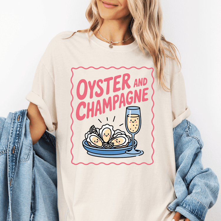 A woman wearing a white t-shirt with a graphic design of oysters and champagne glasses.